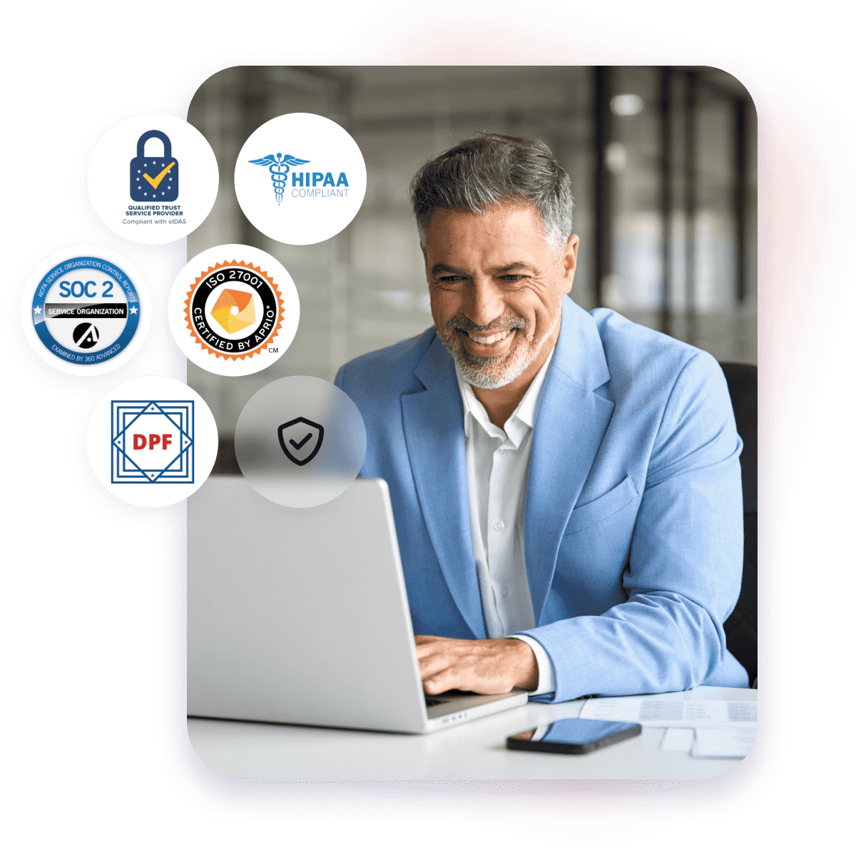 Business man happily working on a computer with security & compliance logos around